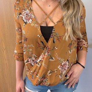 Mid sleeve cross cross floral blouse.